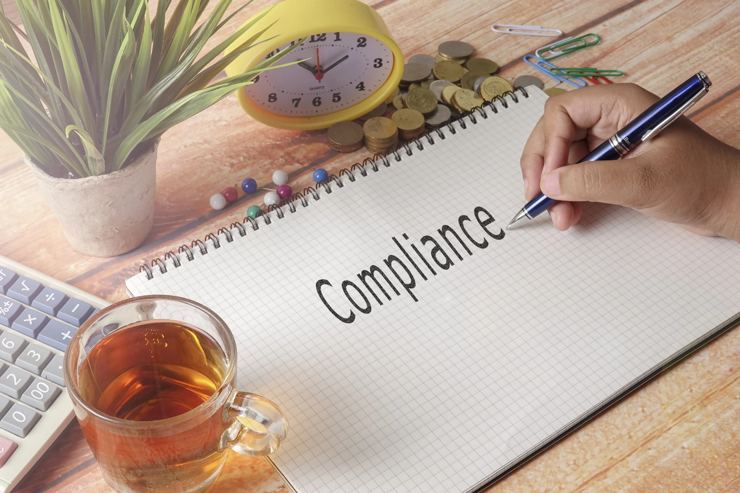 Man,Writing,Compliance,On,The,Notepad.business,Concept